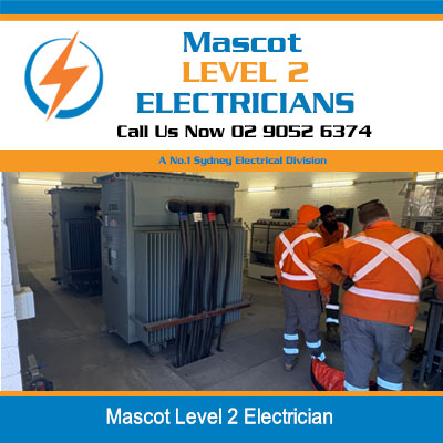 Level 2 electricians in orange high-visibility workwear inspecting an electrical transformer at Mascot