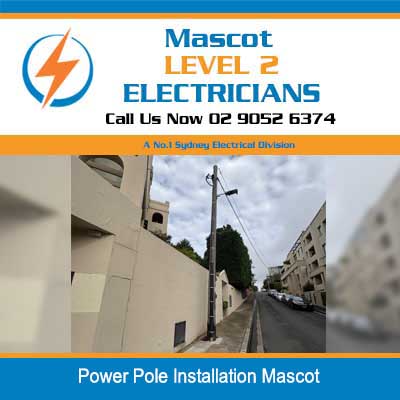 Wooden power pole installation along residential street in Mascot